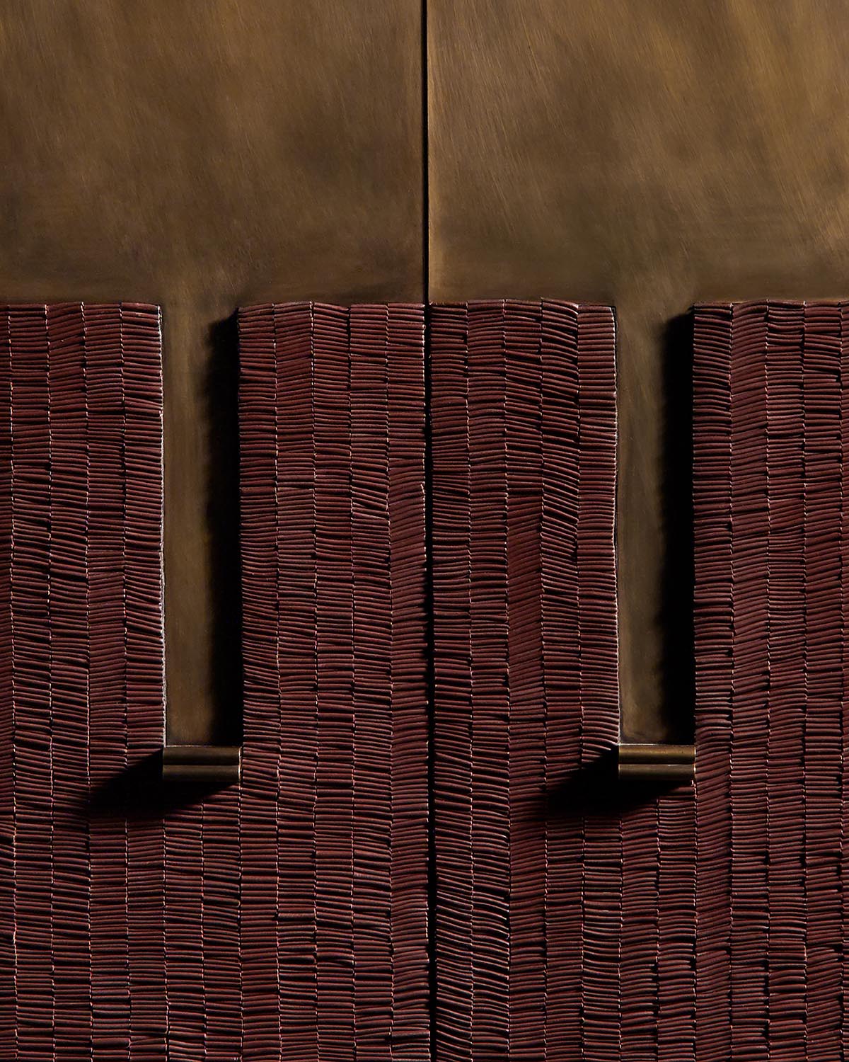 Close-up of stacked rectangular red bricks casting shadows against a smooth brown background surface
