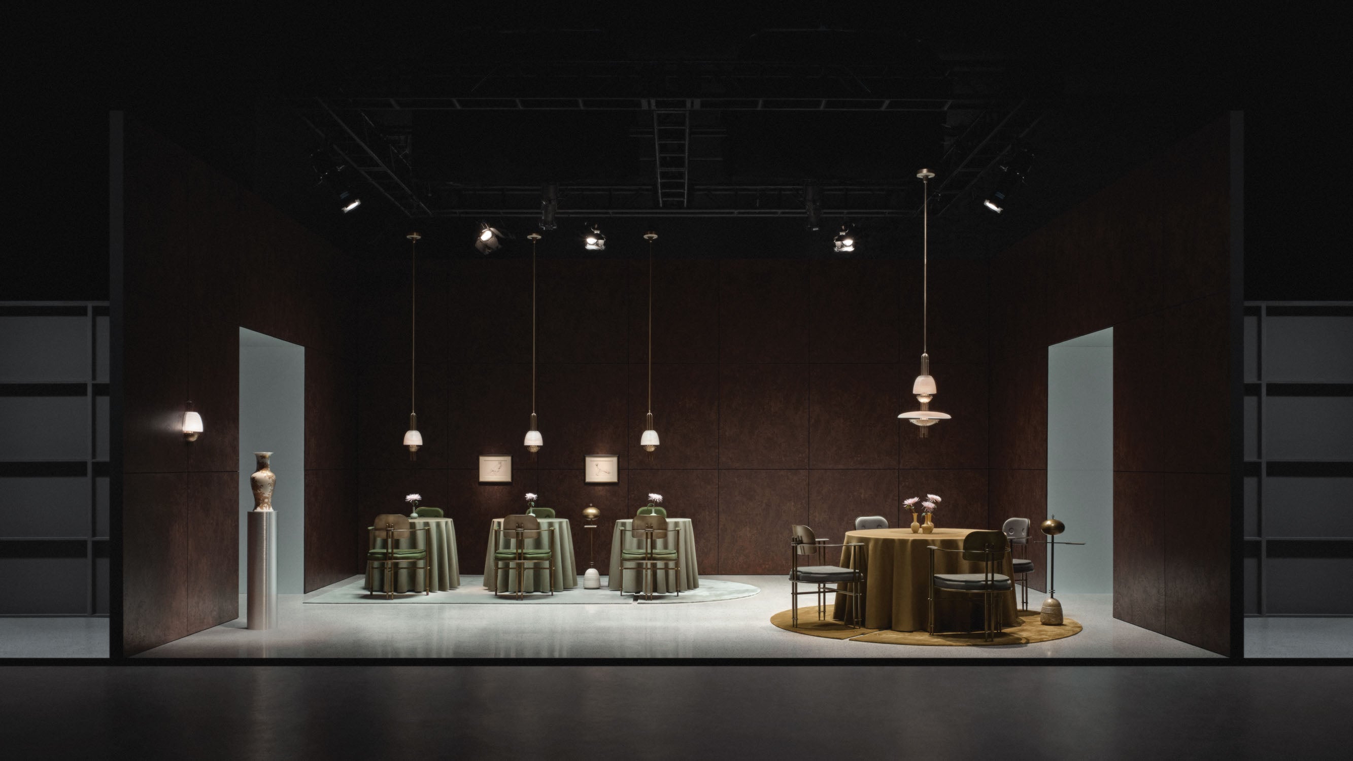 Spacious dark room with modern minimalistic furniture including tables draped with cloth and pendant lights hanging from the ceiling