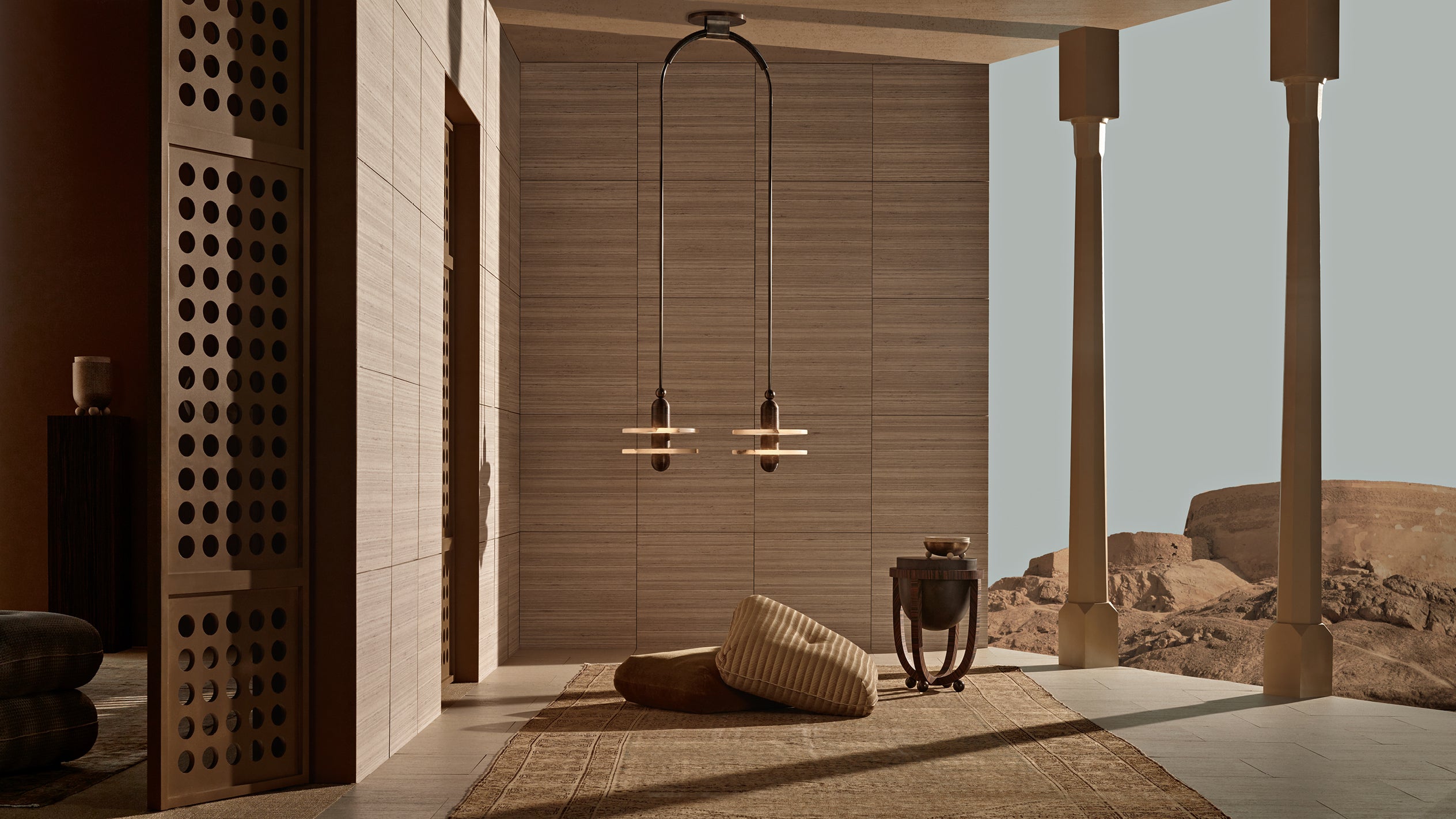 Minimalist outdoor seating area with wooden panel walls, hanging pendant lights, woven cushions, and desert landscape view