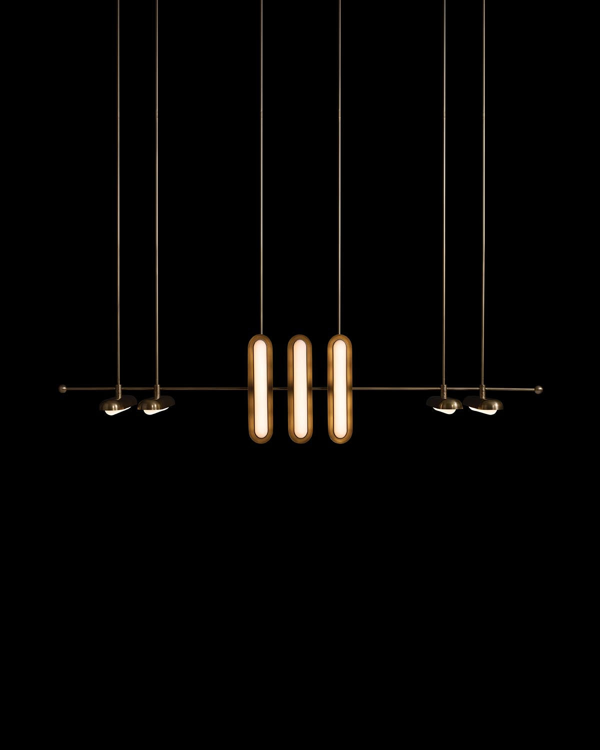 Modern pendant light fixture with three elongated vertical lights and six adjustable spotlights on dark background