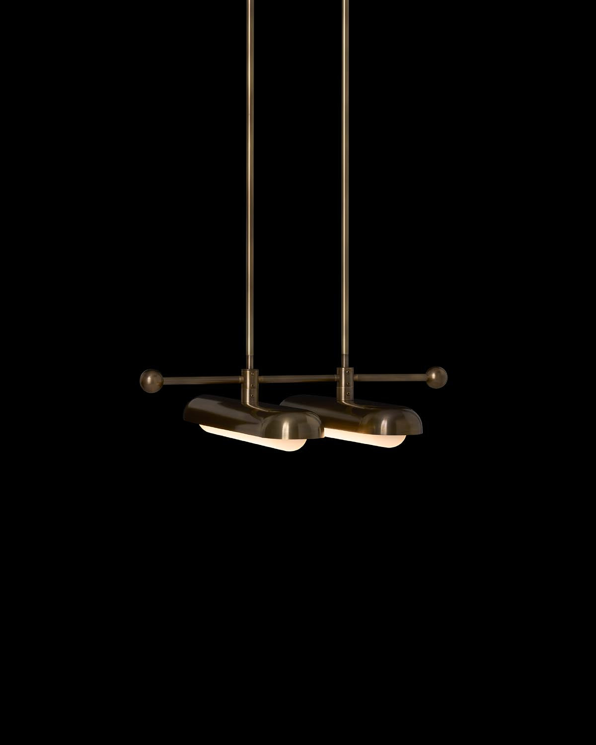 Two modern bronze pendant lights with horizontal rods and rounded shades against a black background
