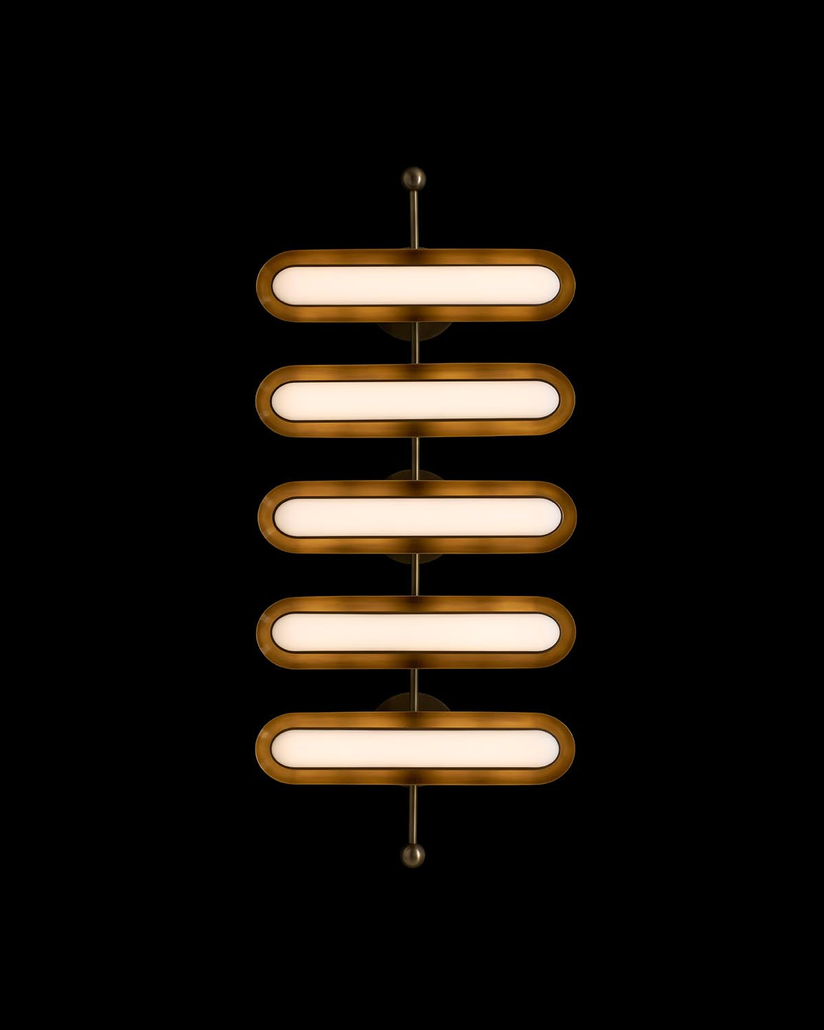 Vertical contemporary light fixture with five elongated rounded rectangular lamps and brass accents on black background