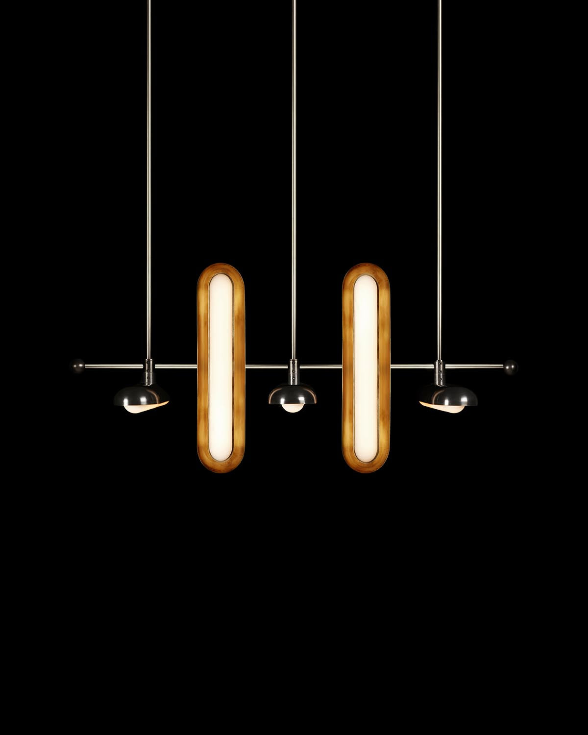 Modern pendant light fixture with elongated wooden oval lights and small black directional spotlights on metal rods against black background