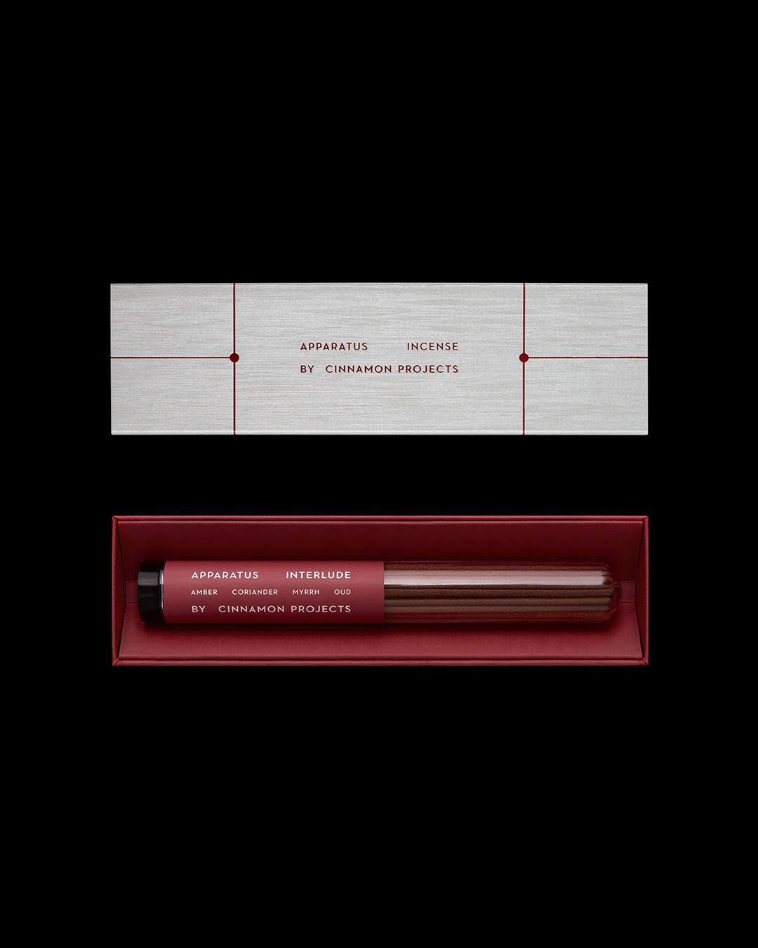 Minimalist flat lay of Apparatus Incense Interlude set by Cinnamon Projects with red label tube and textured silver box on black background