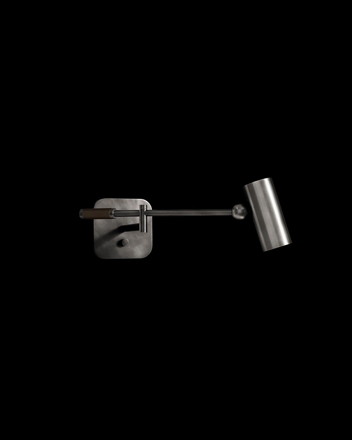 Metallic cylinder reading sconce with adjustable arm and square wall mount against a black background