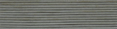 Close-up of weathered horizontal wooden slats with visible grain and slight gaps in a muted gray tone