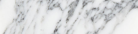 Close-up of white marble surface with grey and black natural veining and smooth polished texture