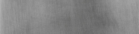 Close-up of brushed aluminum surface showing fine linear texture and subtle variations in matte finish across the metal
