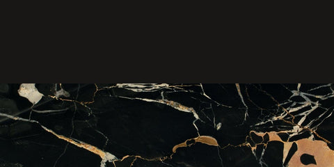 Close-up of black marble surface with beige and white veining patterns on a dark background