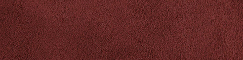 Close-up of rich tomato-red suede fabric with a smooth, fine texture and natural depth in color throughout the surface
