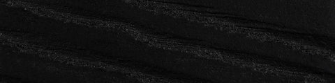 Close-up of textured black fabric with subtle horizontal ridges and a matte finish against a dark background