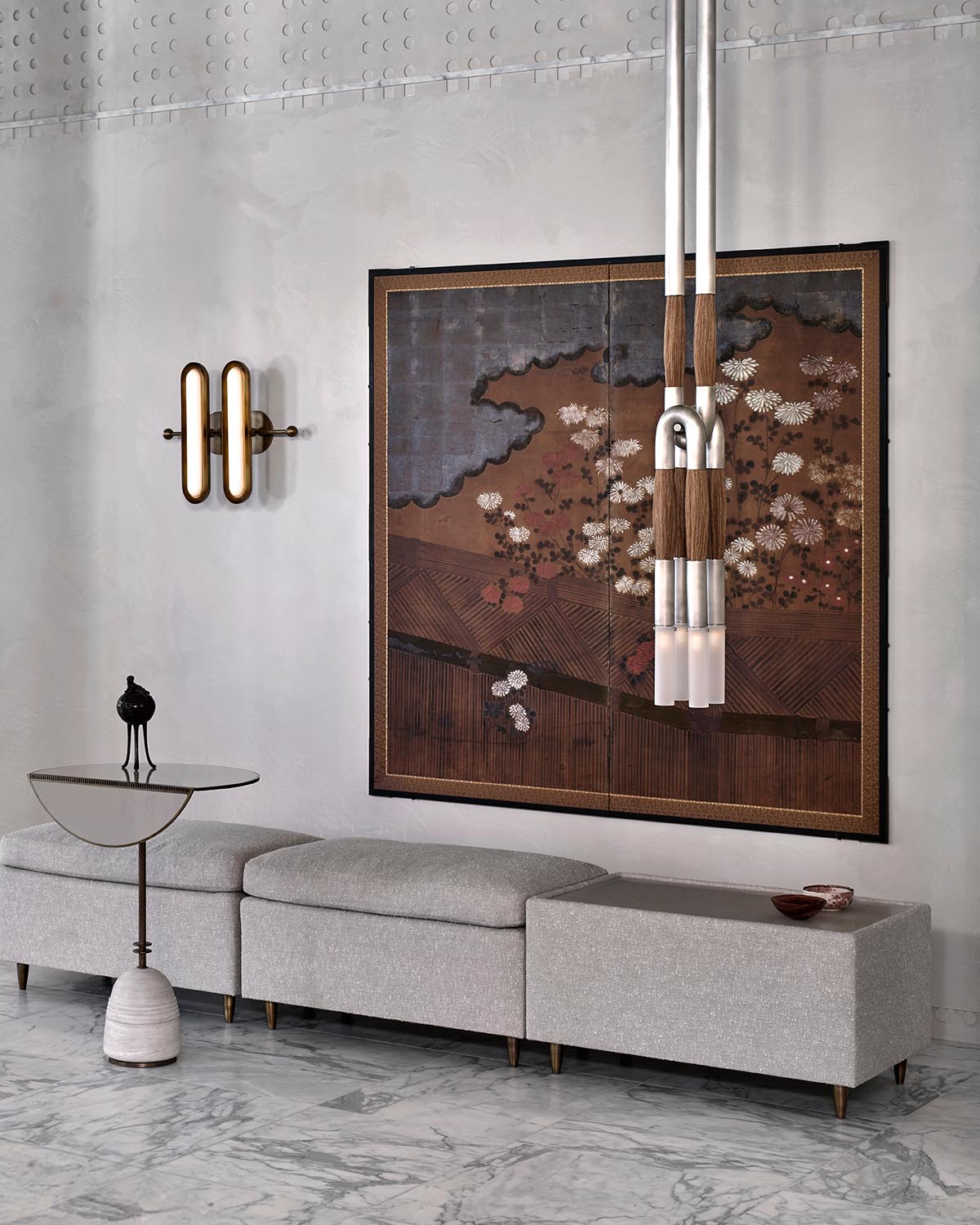 Modern living room with a gray modular sofa, round side table, abstract wall art, and horsehair pendant light fixture