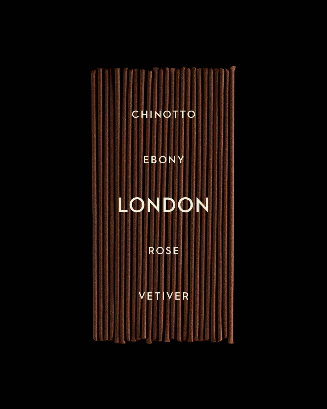 Close-up of neatly arranged brown incense sticks with white text listing fragrance notes on a black background