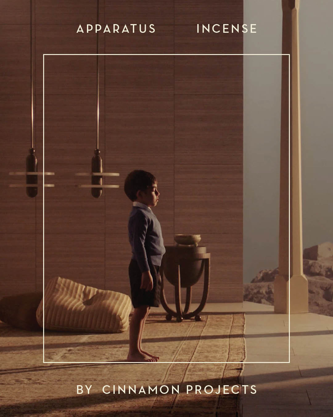 Young child standing barefoot on a woven rug in a minimalist indoor space with wooden walls and soft lighting