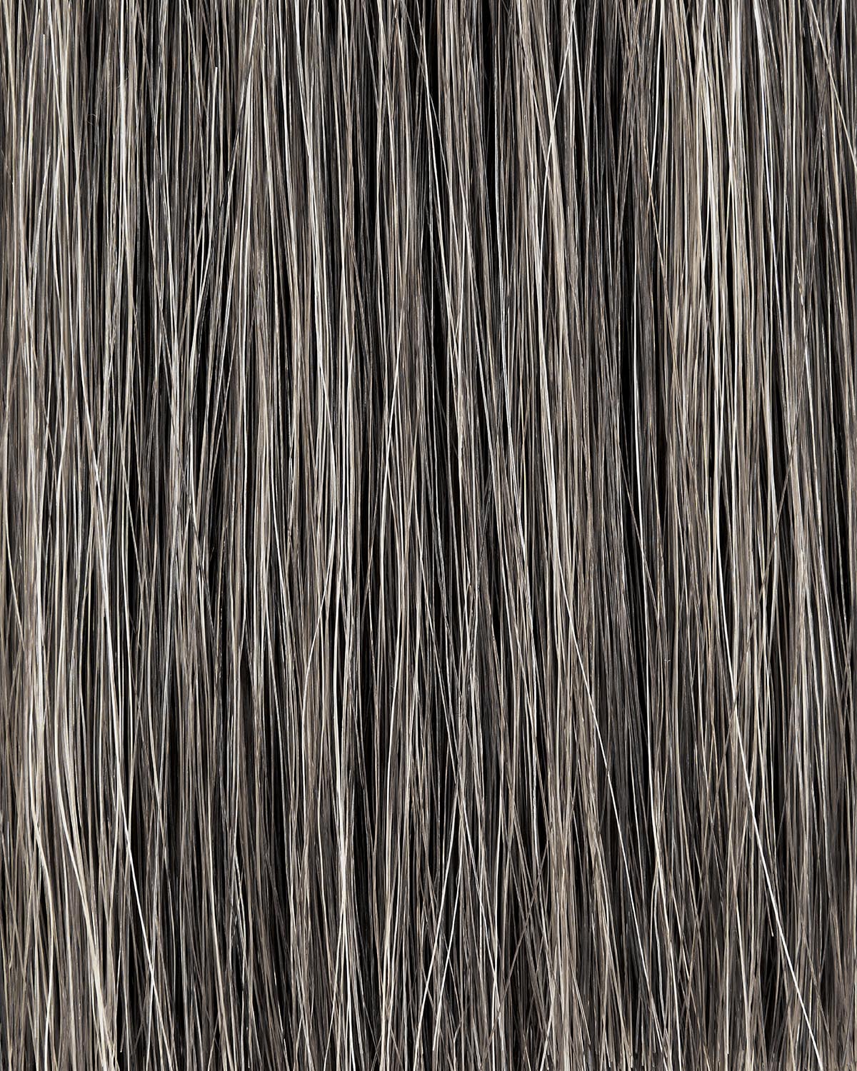 Close-up of vertically aligned strands of dark and light gray textured hair or fibers on a neutral background