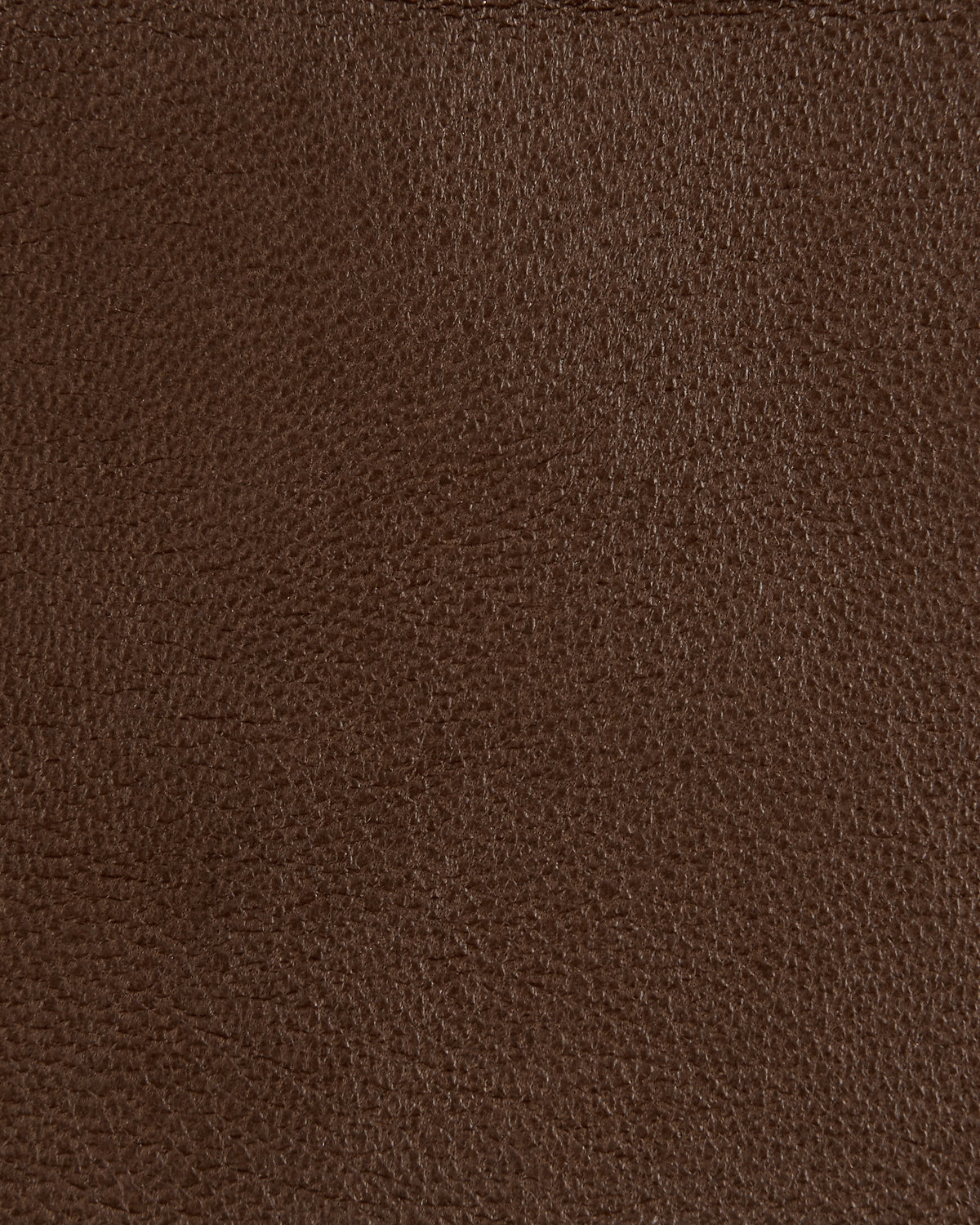 Close-up of dark brown textured leather surface showing natural grain pattern and subtle creases.