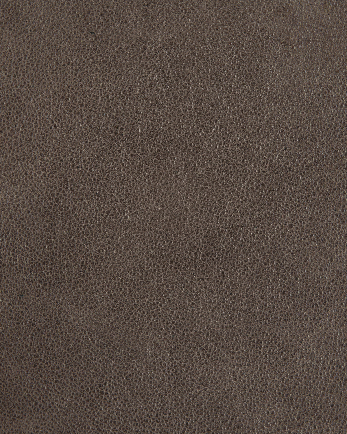 Close-up of dark brown textured leather surface with fine grain pattern and subtle color variations