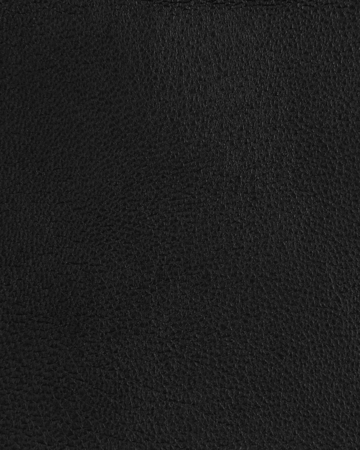 Close-up of black textured leather surface with subtle grain pattern and natural creases.