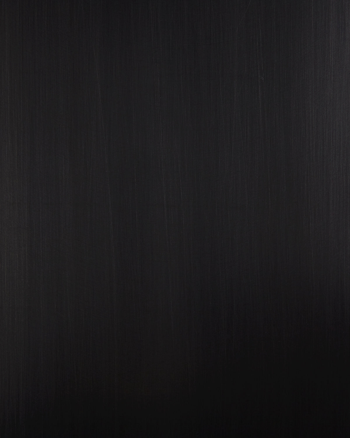 Close-up of a dark textured surface with subtle vertical grain pattern and soft lighting effects