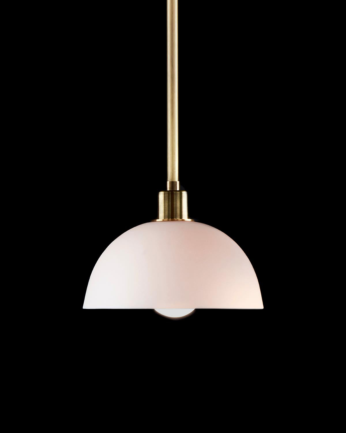 Minimalist pendant light with a frosted white glass dome shade and brushed brass stem against black background