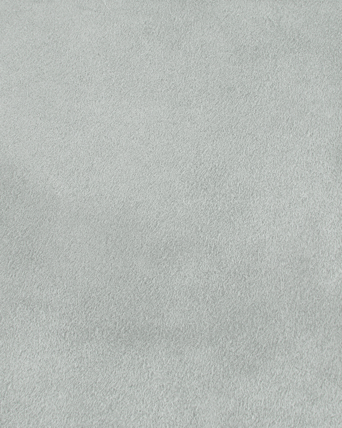 Close-up of a smooth light grey suede texture with soft, fine grain and subtle shading variations