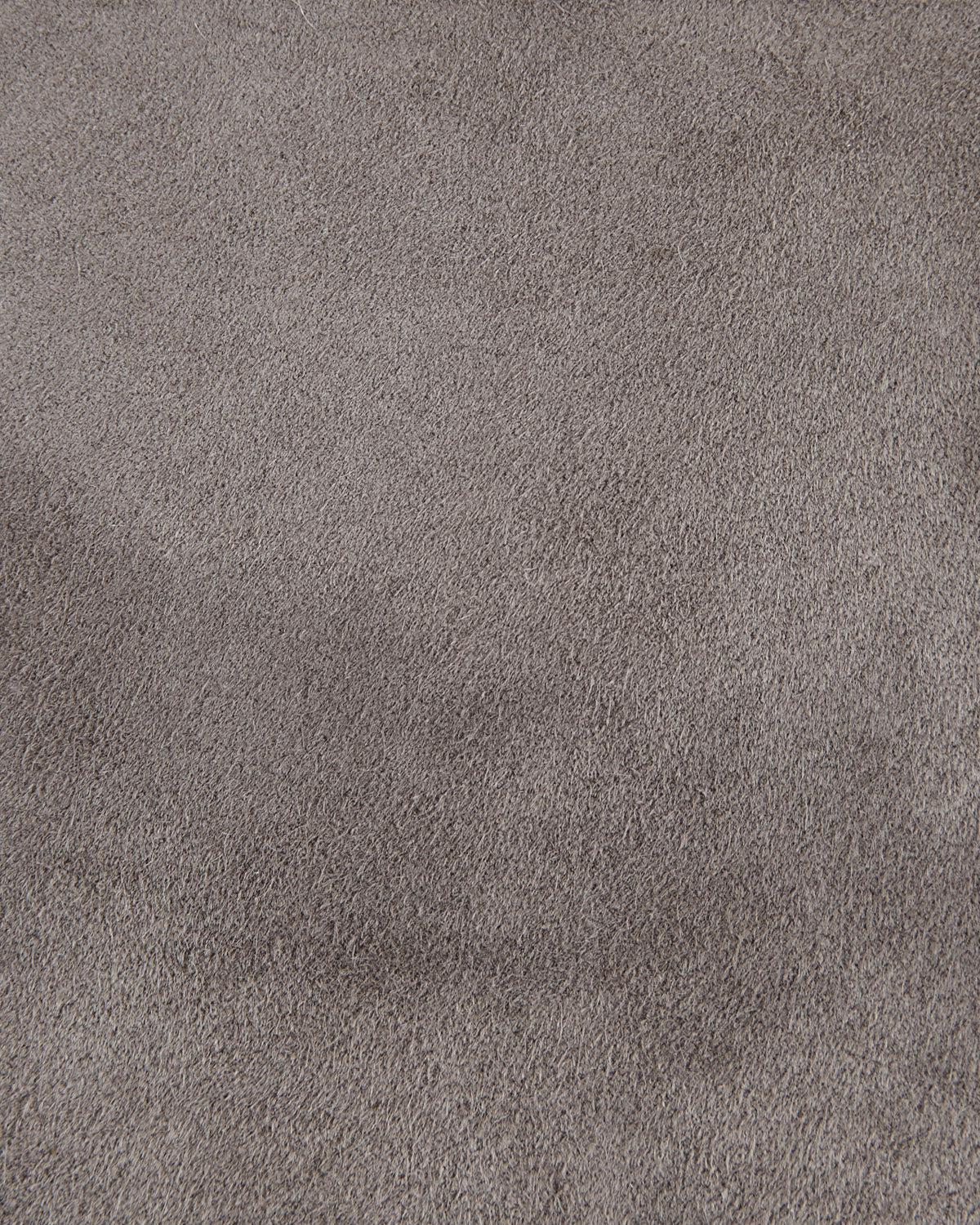 Close-up of soft gray textured fabric with a uniform pile surface and subtle variations in shading