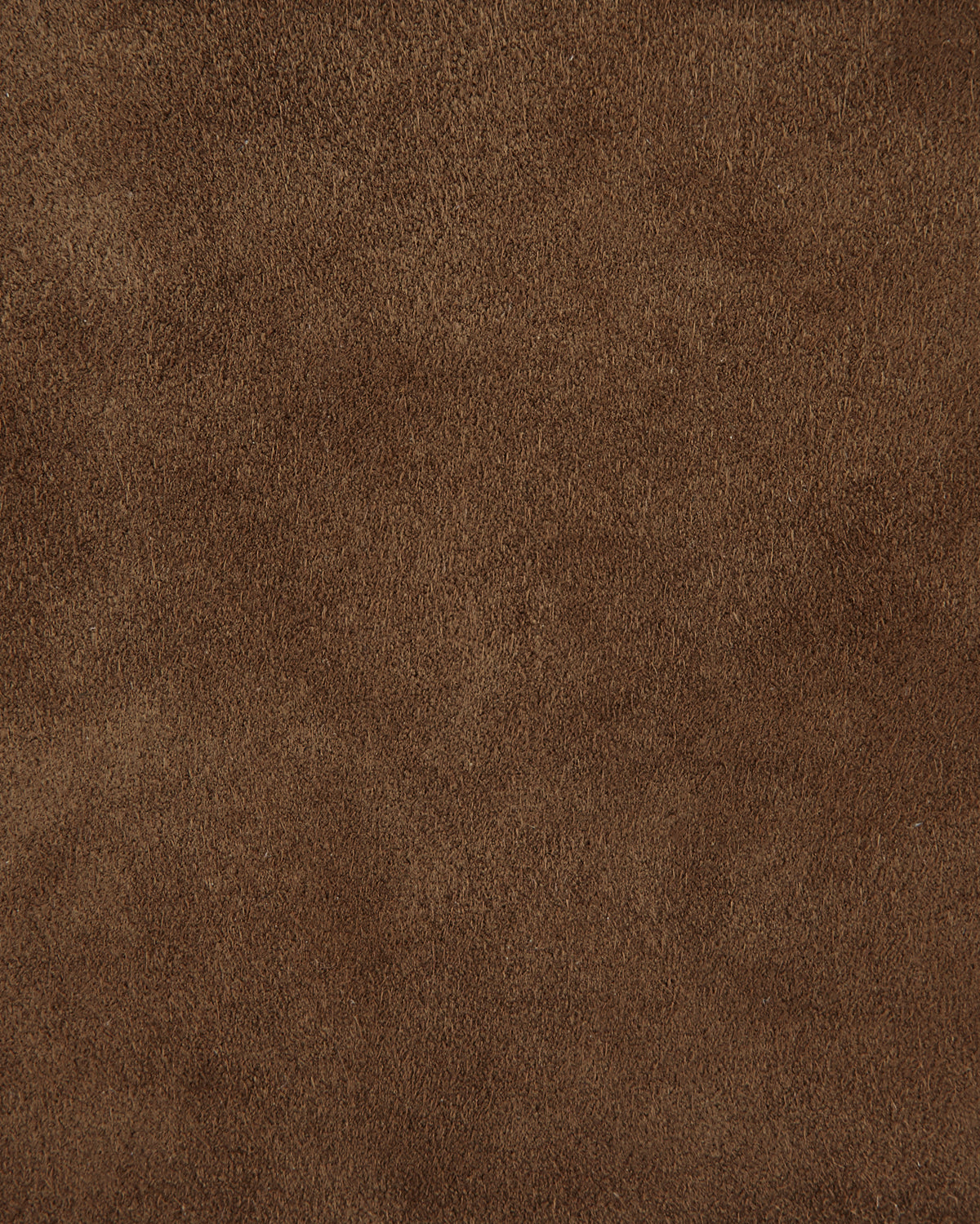 Close-up of brown microfiber fabric texture with a soft, velvety surface and fine fibers evenly distributed