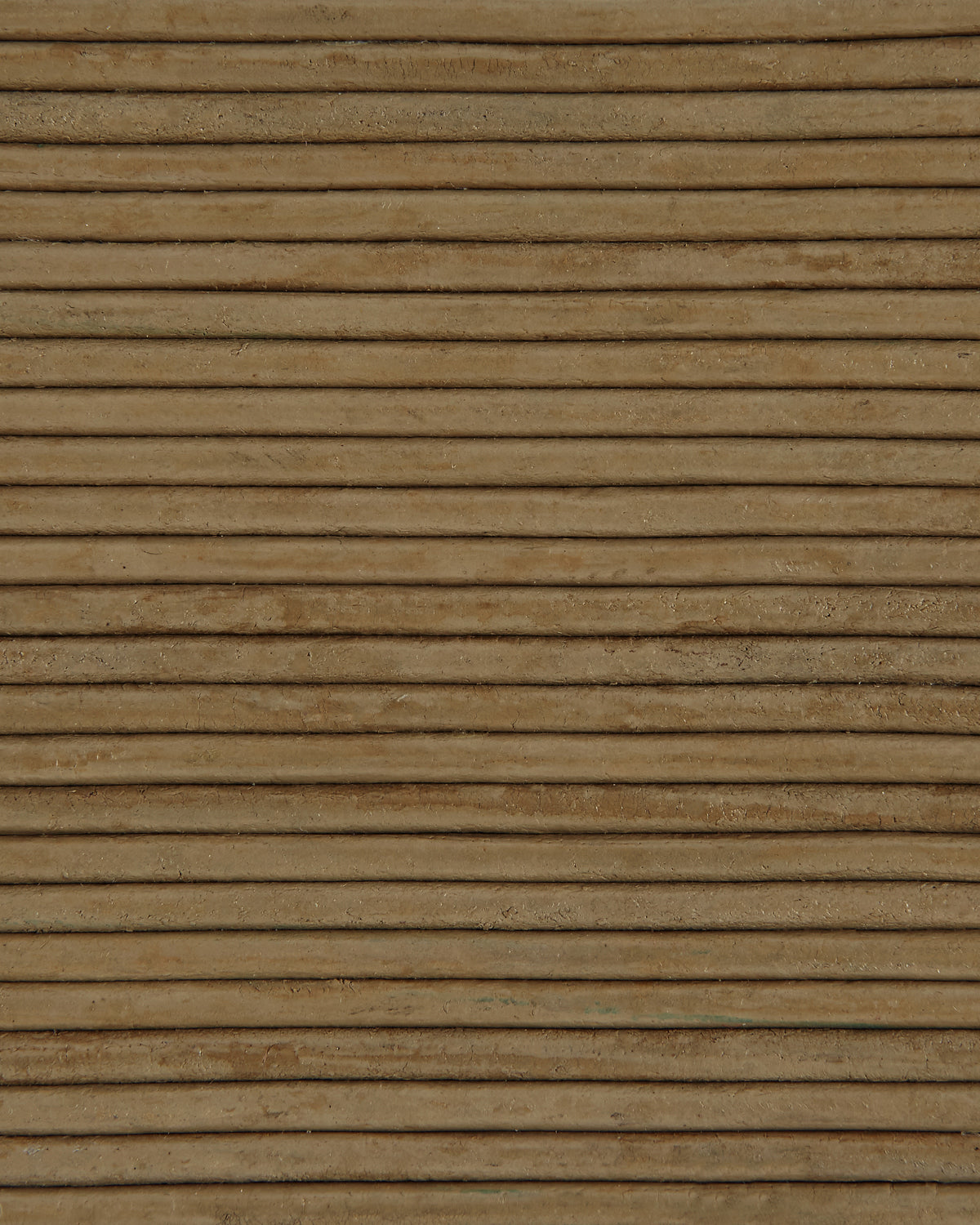 Close-up of horizontally grooved light brown surface with subtle texture and natural imperfections