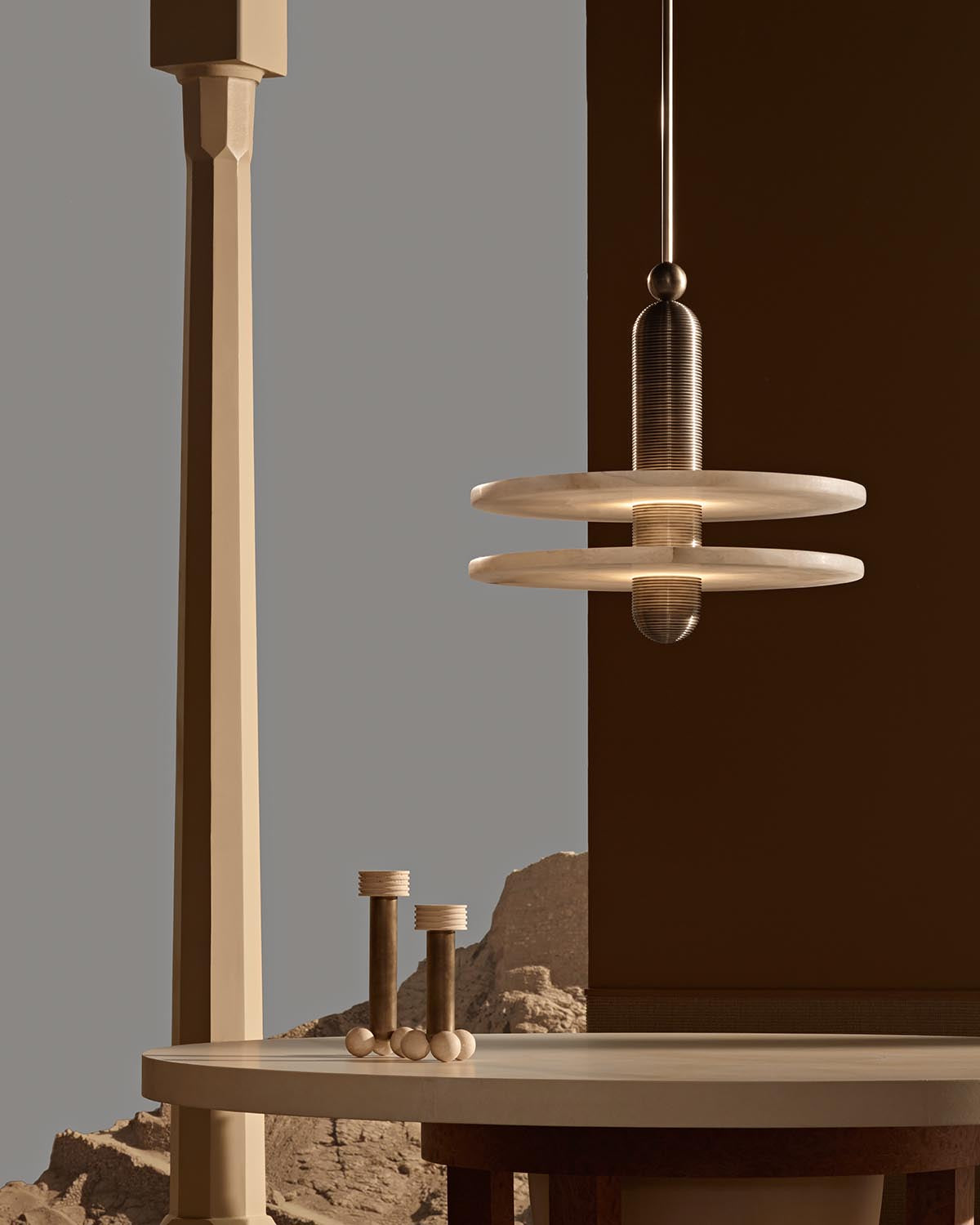Modern pendant light with two wide flat circular shades and a textured cylindrical fixture hanging above a round table