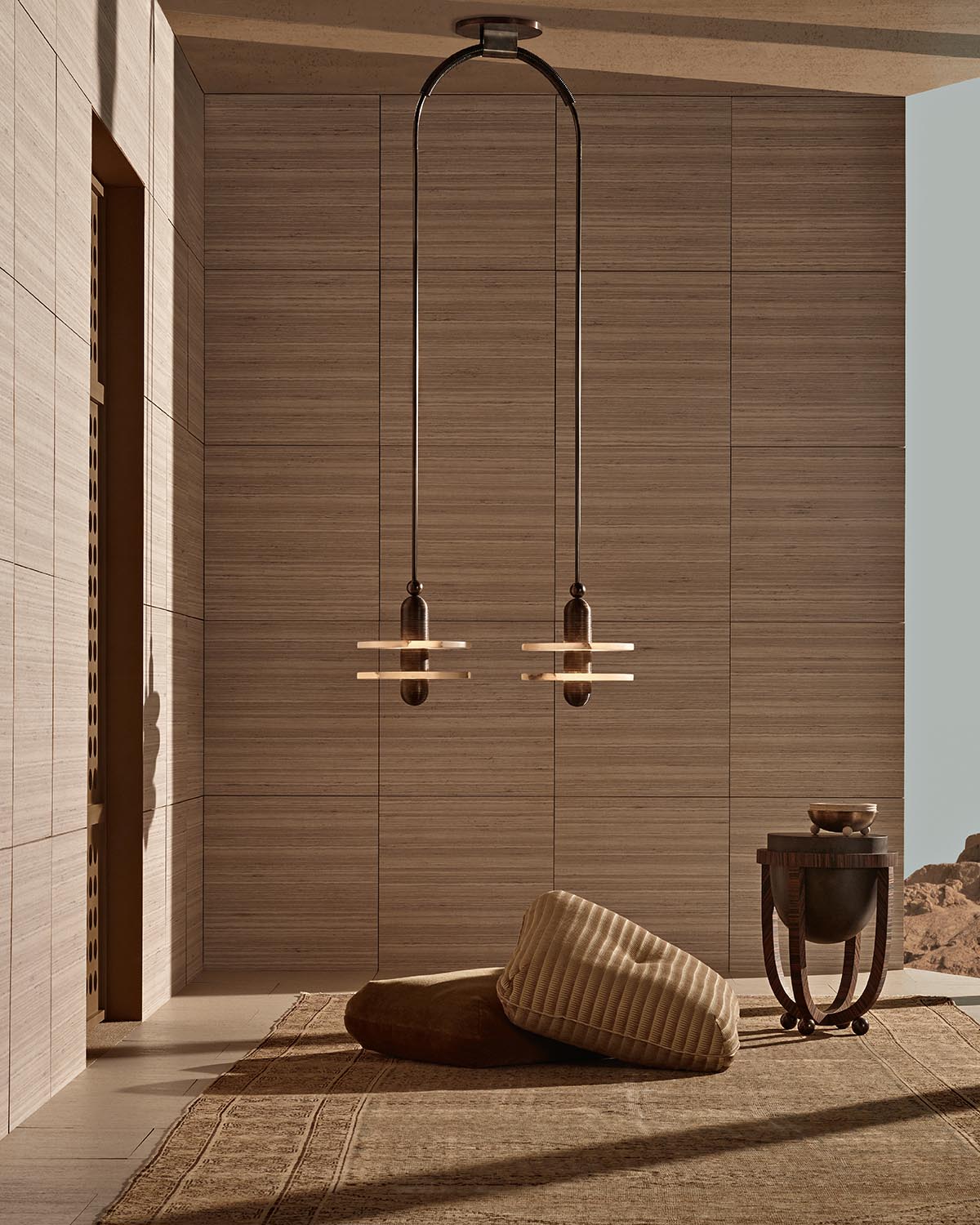 Minimalist interior with MEDIAN 2 pendant lights hanging over textured floor cushions and a dark wooden side table