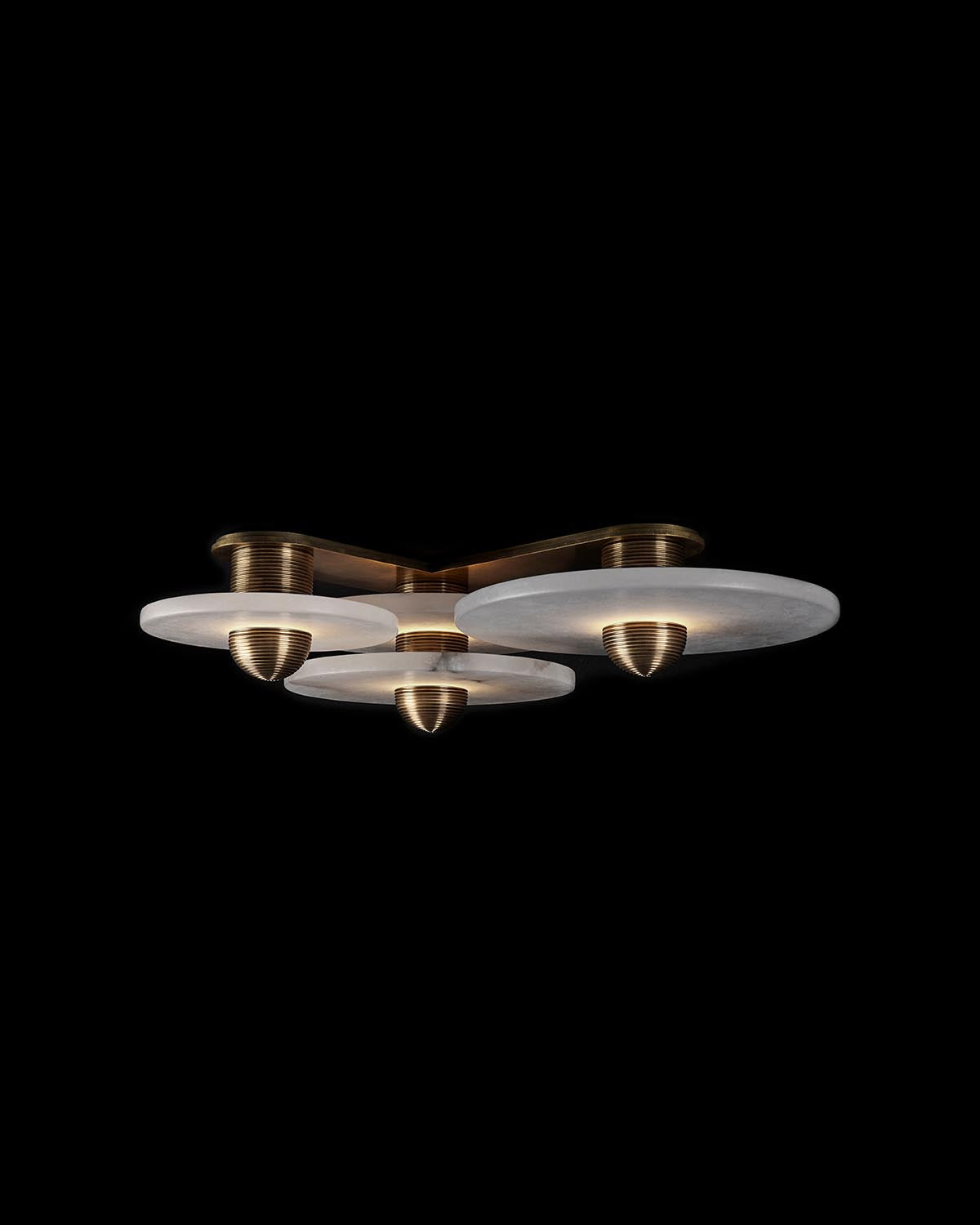 Modern ceiling light fixture with three round white marble surfaces and brass accents on black background