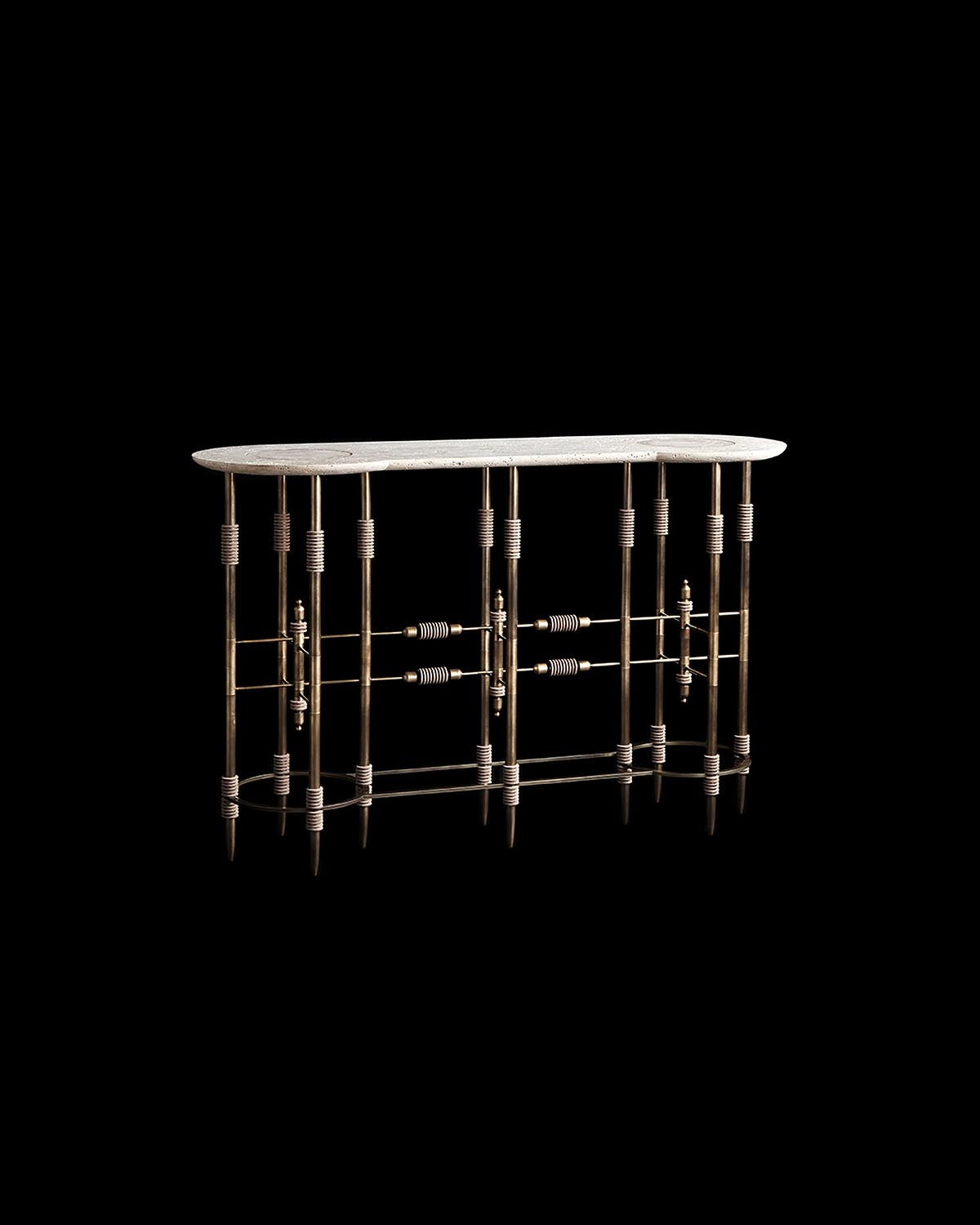 Oval stone console table top with decorative metal legs featuring cylindrical and horizontal rod details on black background