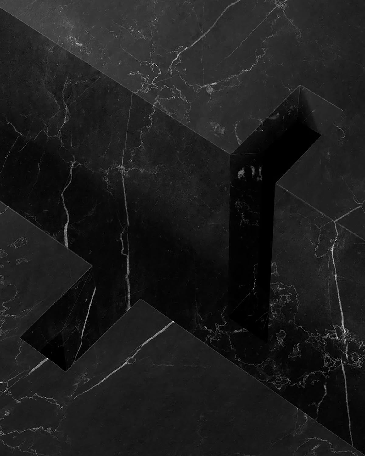 Close-up of a sleek black marble coffee table with sharp geometric cutouts and subtle white veining details