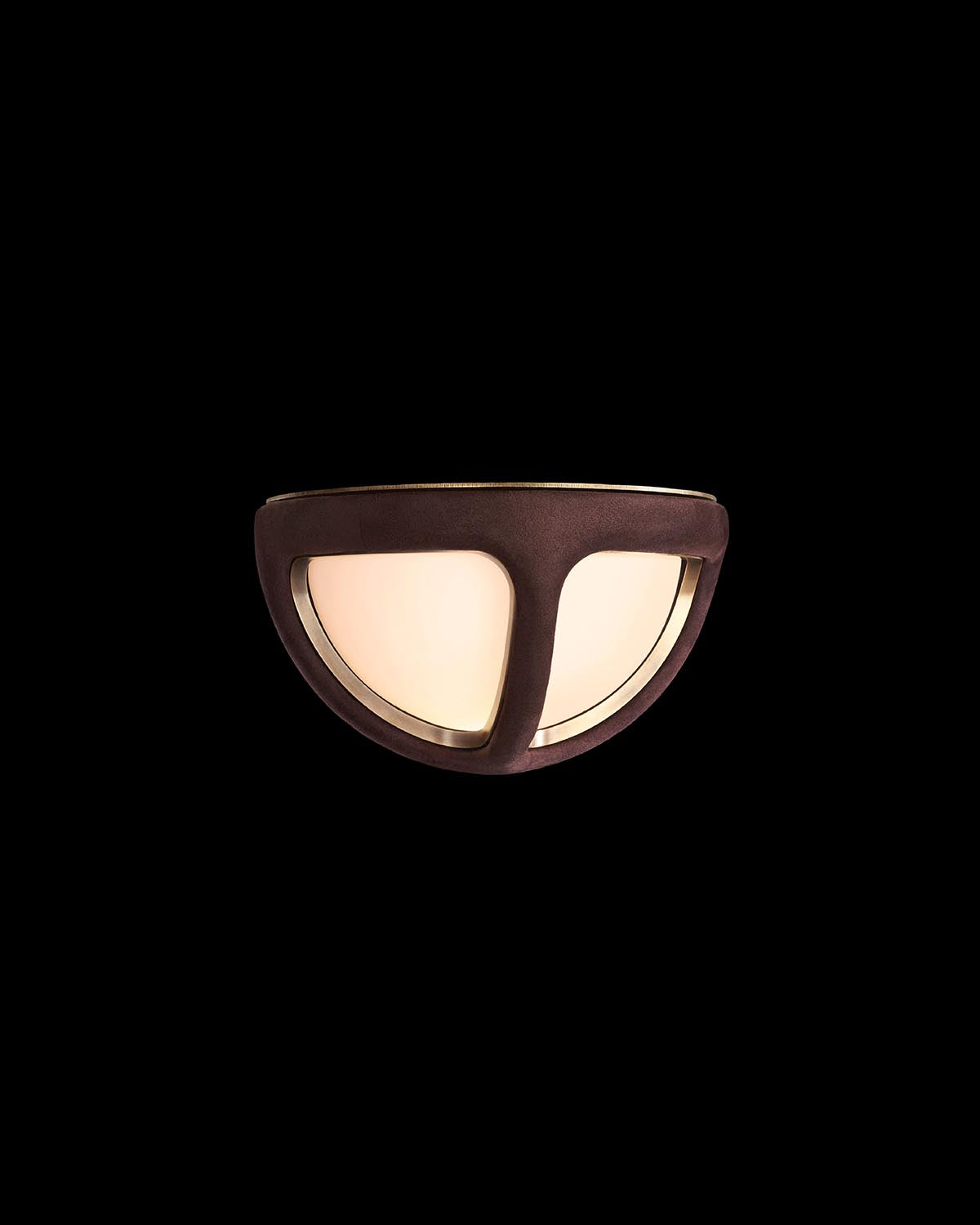 Close-up of semi-circular ceiling light with frosted glass and dark bronze frame against black background