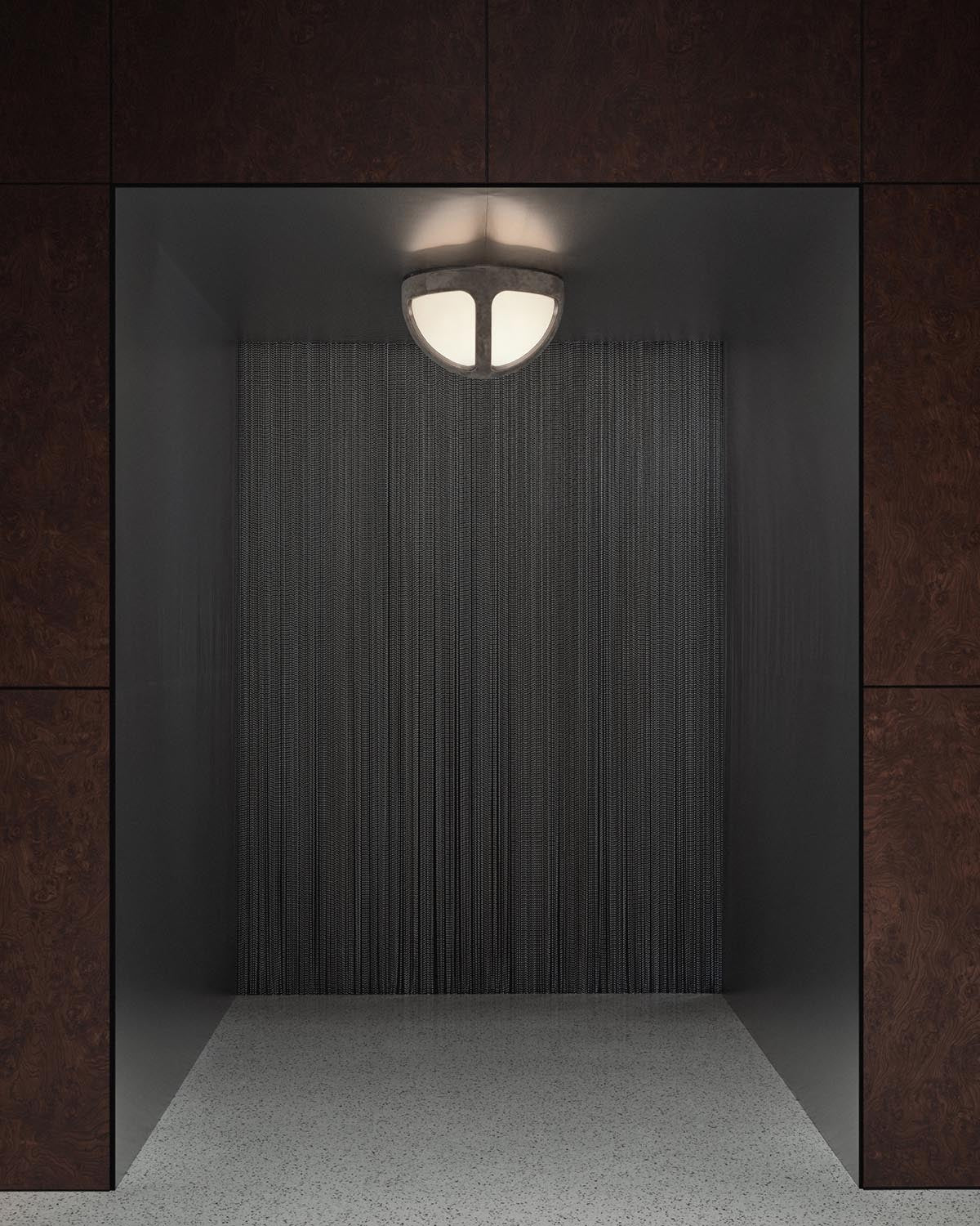 Minimalist ceiling light fixture with segmented frosted glass panels in a dark recessed niche with textured backdrop