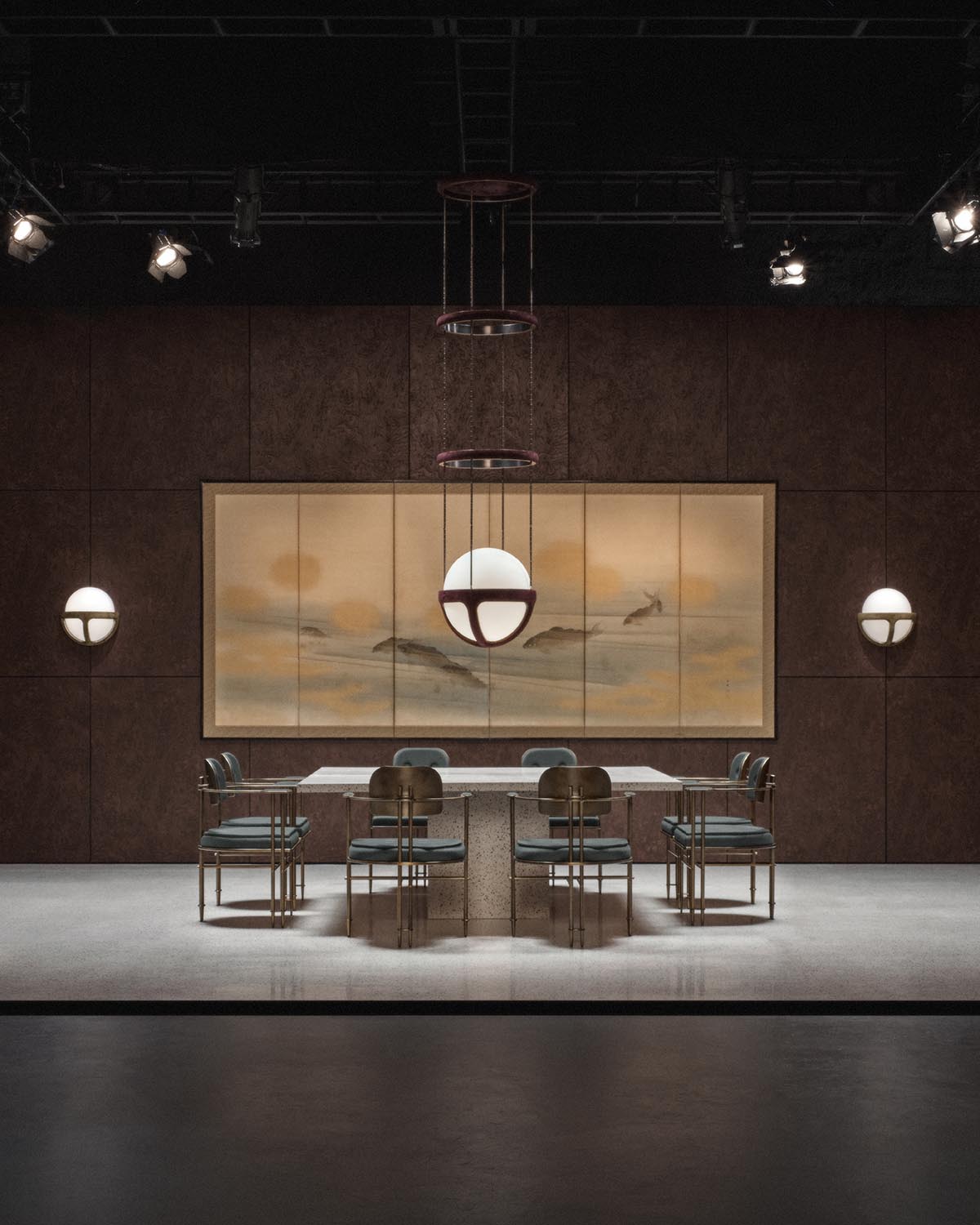 Dining area with a rectangular stone table, six metal and leather chairs, spherical pendant and wall sconces, and abstract art panel backdrop
