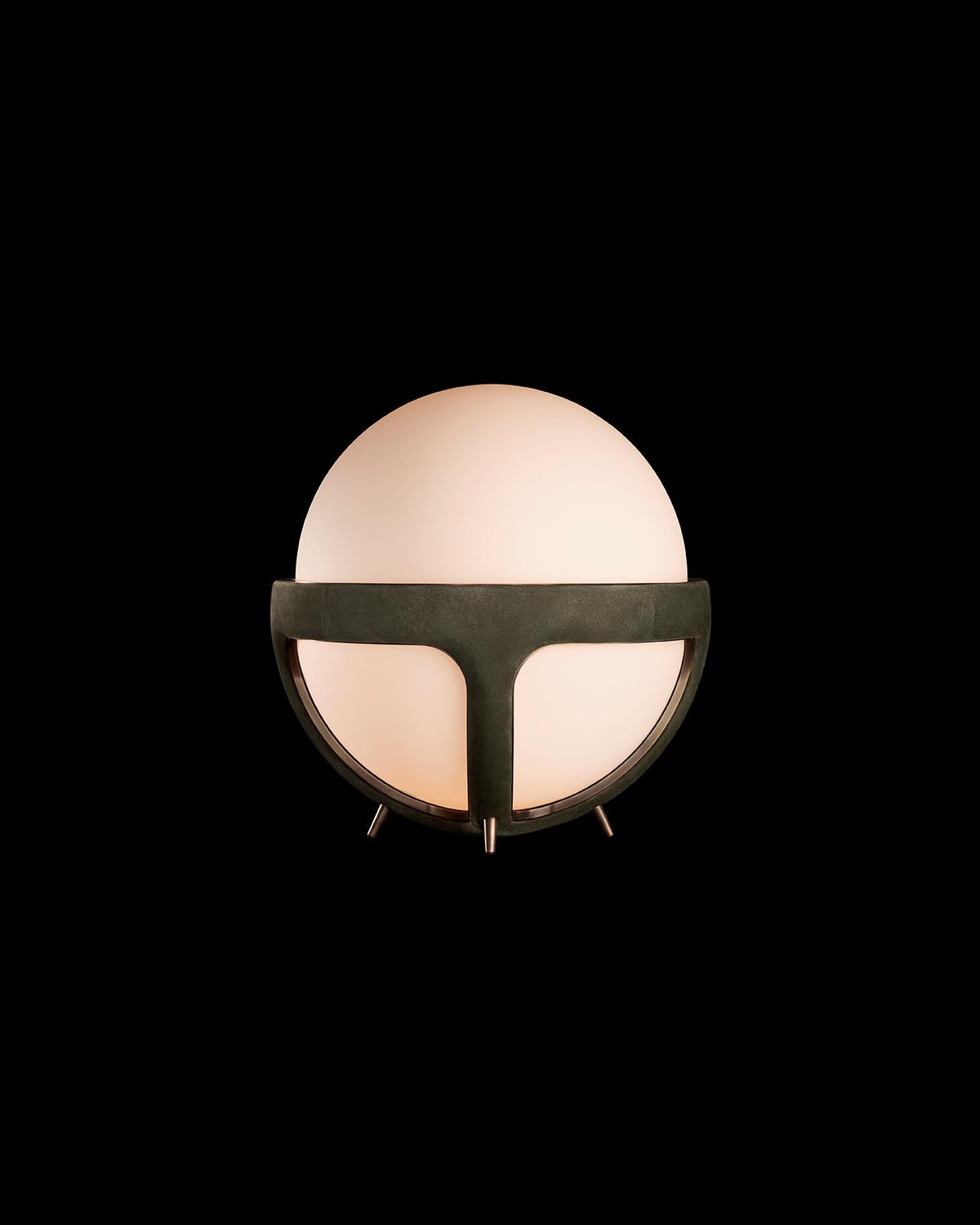 Glowing spherical table lamp with matte black metal frame and three small legs against a black background.