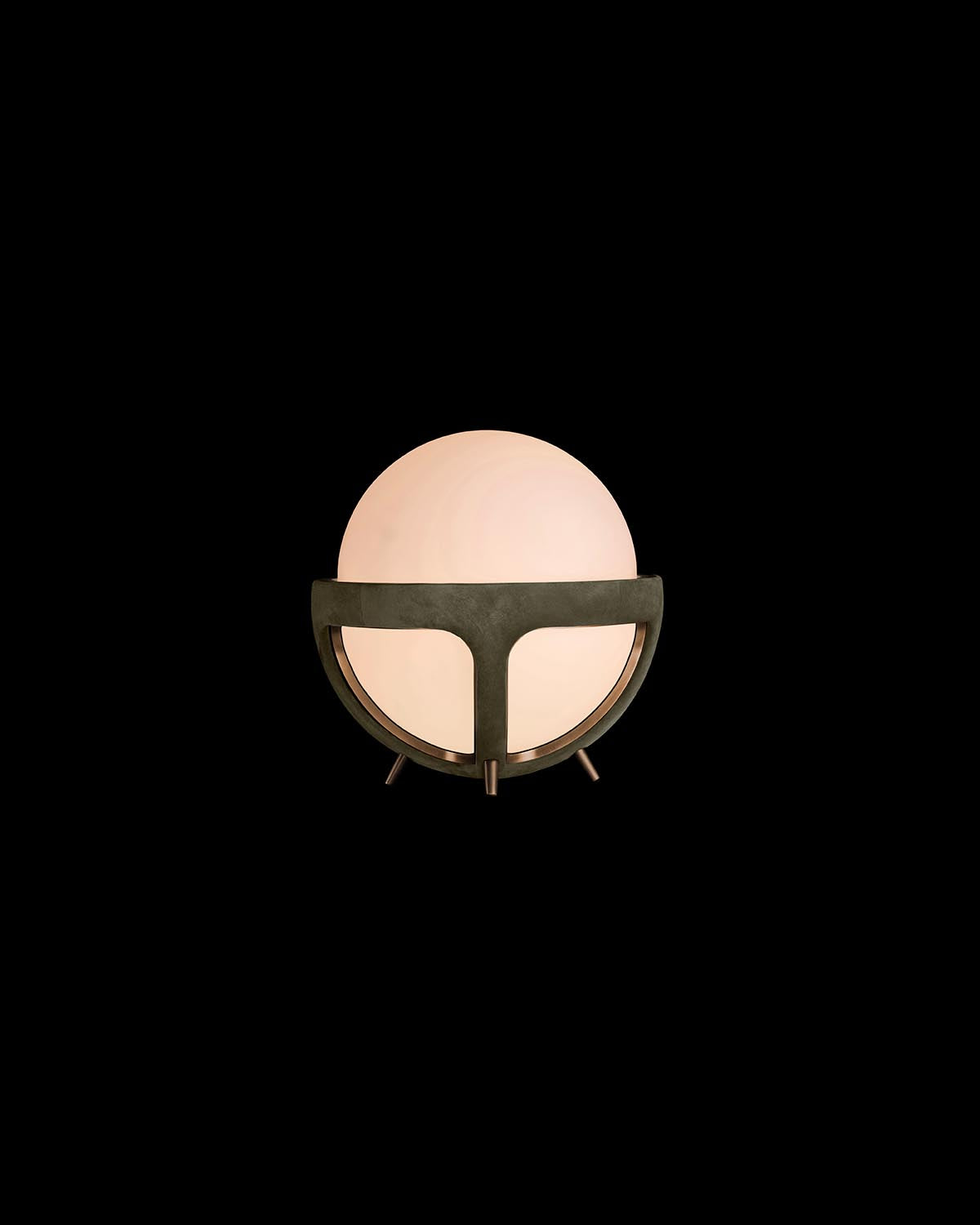 Soft glowing spherical lamp with a matte dark frame and tripod legs set against a black background