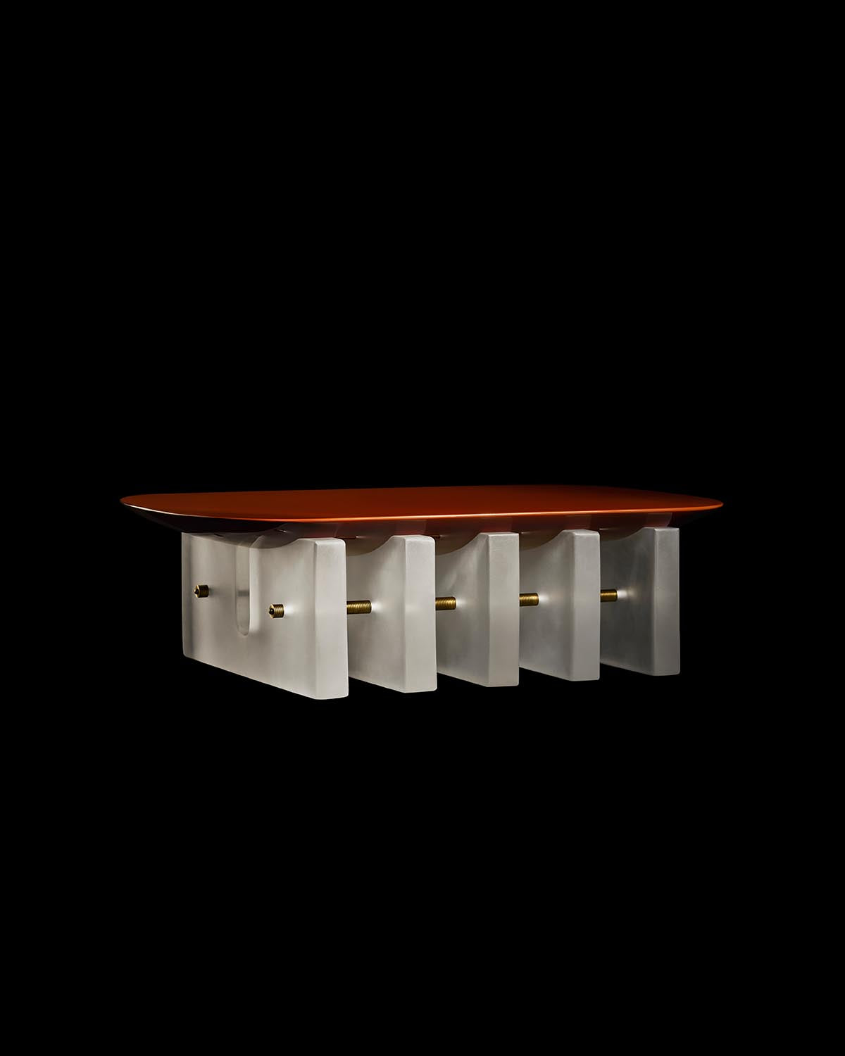 Rectangular coffee table with a smooth reddish-brown top supported by evenly spaced frosted glass panels and brass rods.