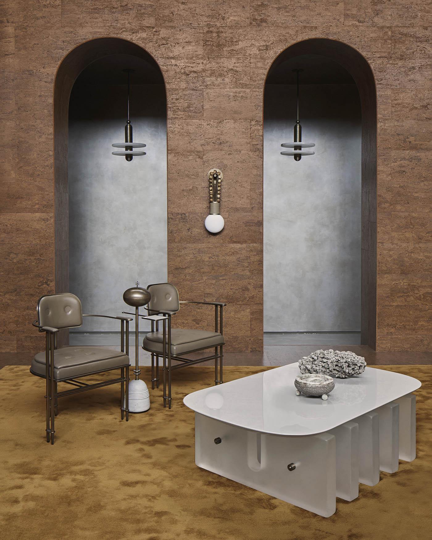 Modern coffee table with a curved white frosted glass top and sculptural base set against a textured brown wall background