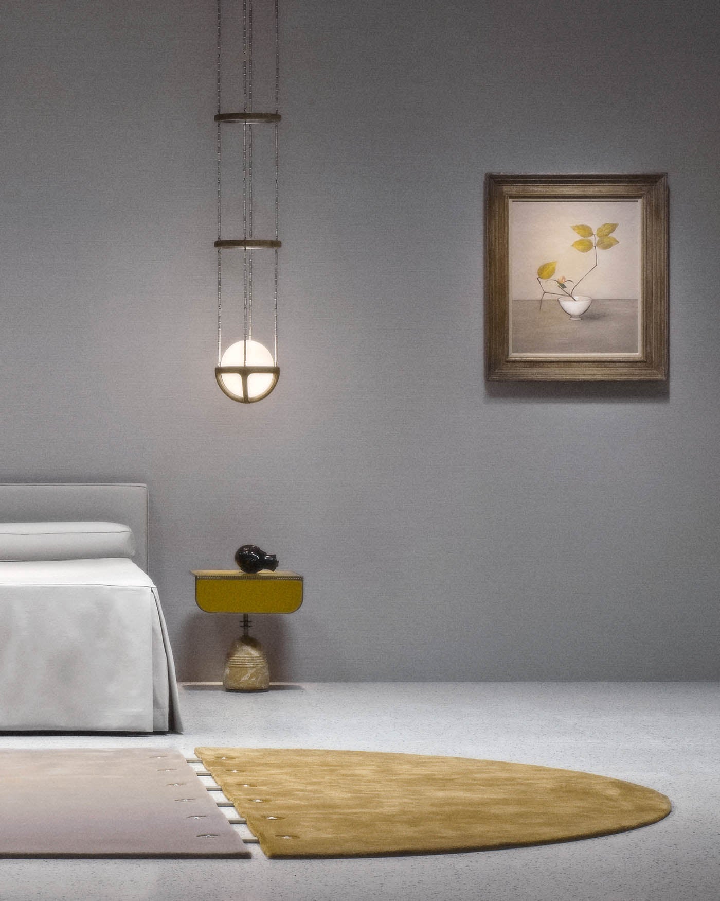 Minimalist bedroom corner with a white bed, hanging round pendant light, yellow side table, and framed botanical artwork