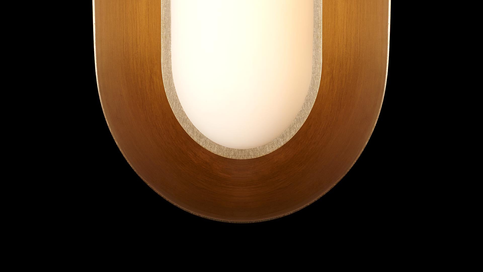 Close-up of a rounded vertical wall lamp with a warm wooden frame and diffused white light against a black background
