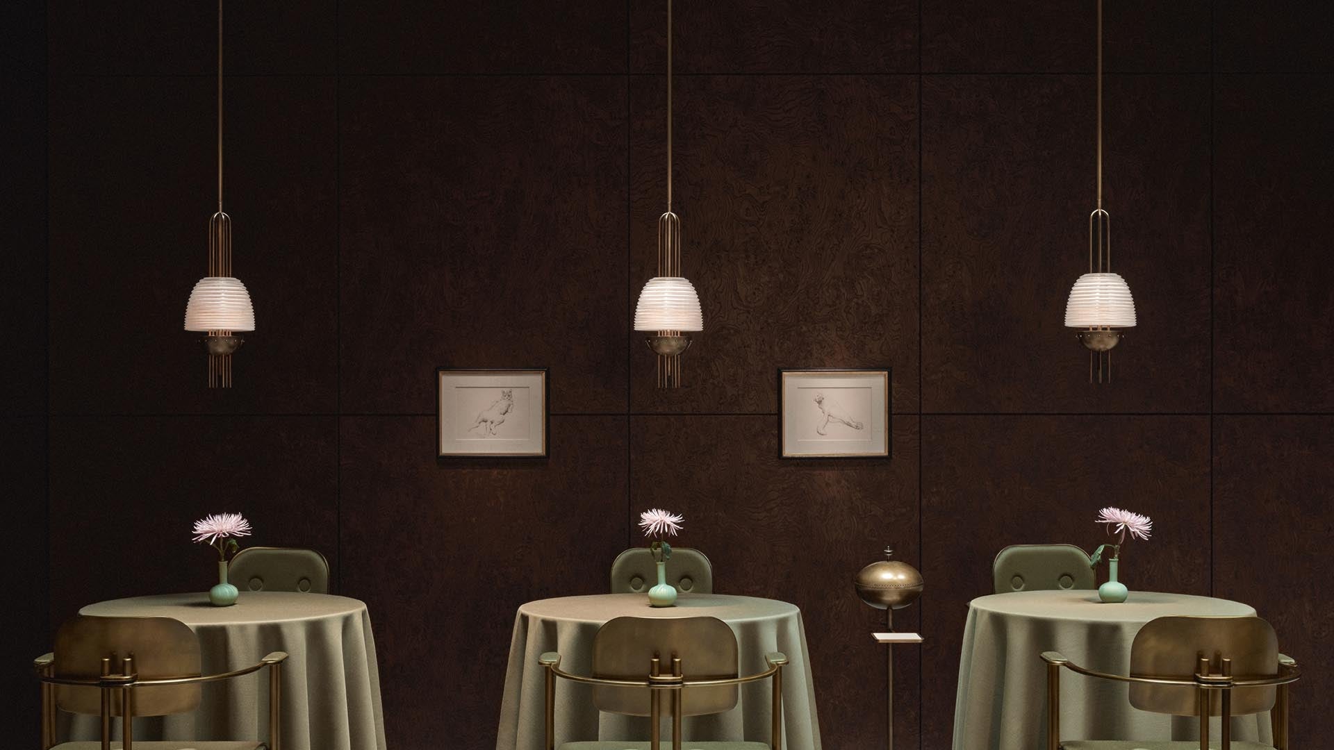 Three small round tables with green velvet chairs, each topped with a vase holding a single pink flower, under pendant lights.