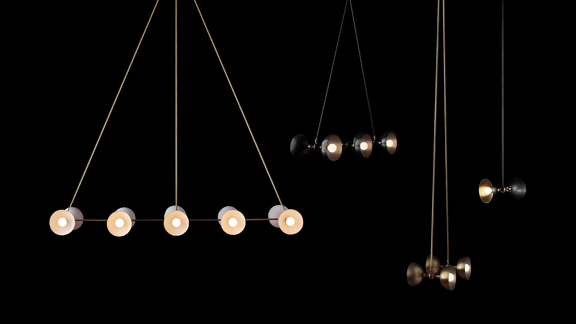 Minimalist pendant lights with multiple round bulbs suspended against a black background in varying arrangements