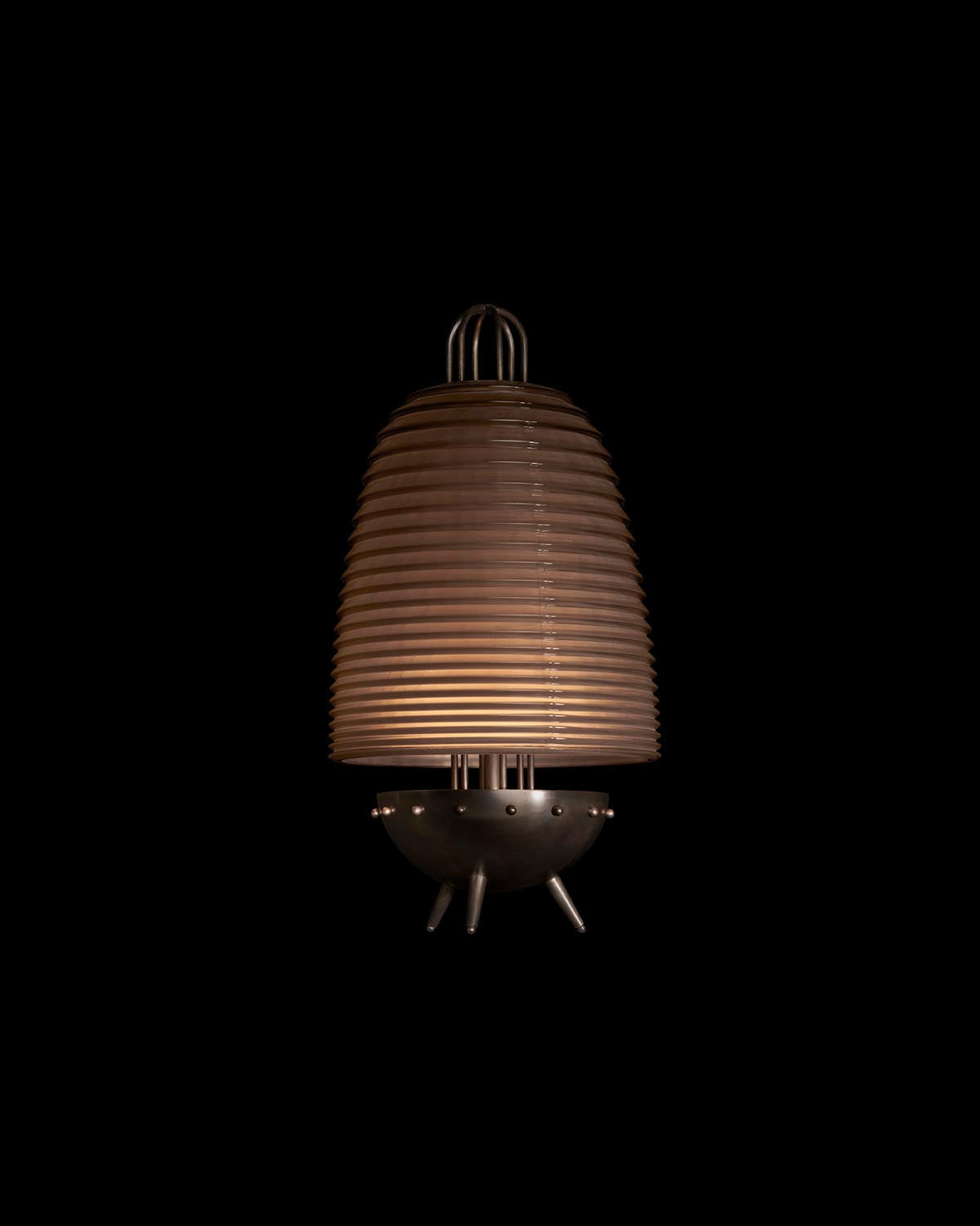 Modern table lamp with ribbed cylindrical shade and rounded metal base on a black background
