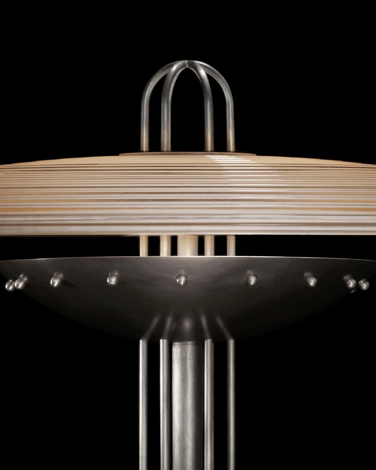 Close-up of SIGNAL Y floor lamp showing layered wooden shade and metallic details against a black background