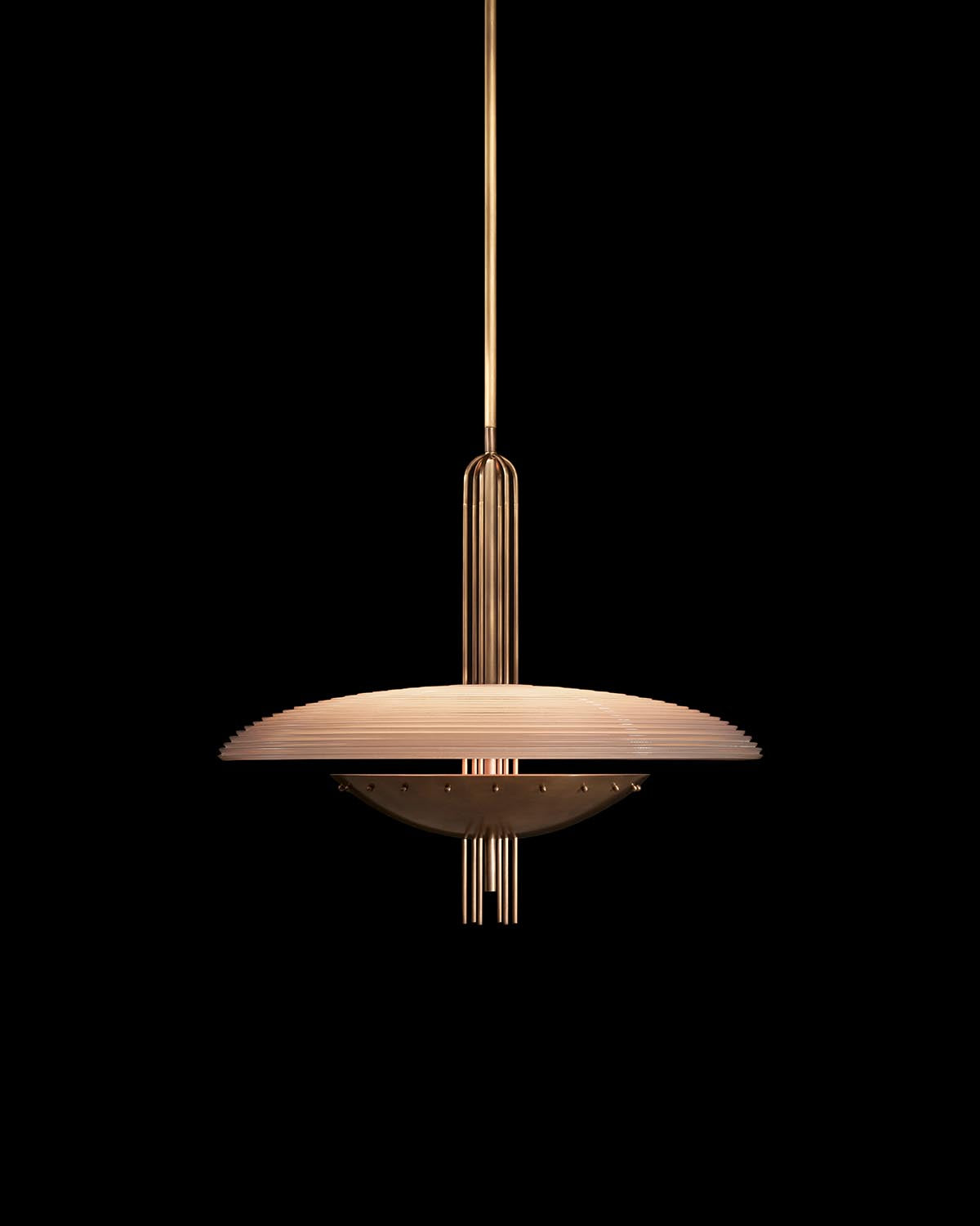Suspended modern pendant light with layered circular shade and vertical metal rods in warm metallic finish against black background