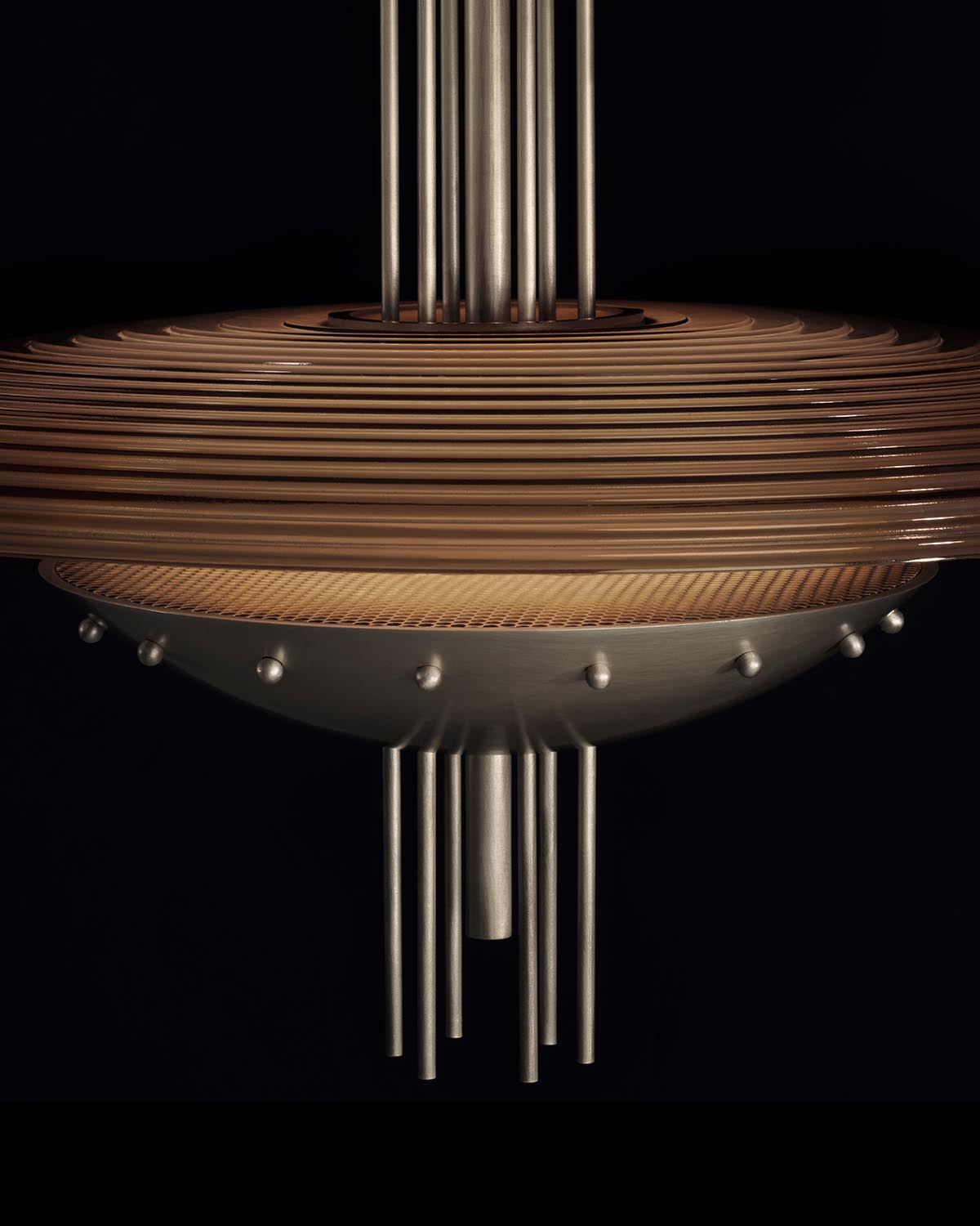 Close-up of SIGNAL Y pendant light featuring concentric wooden rings and vertical metal rods on a dark background