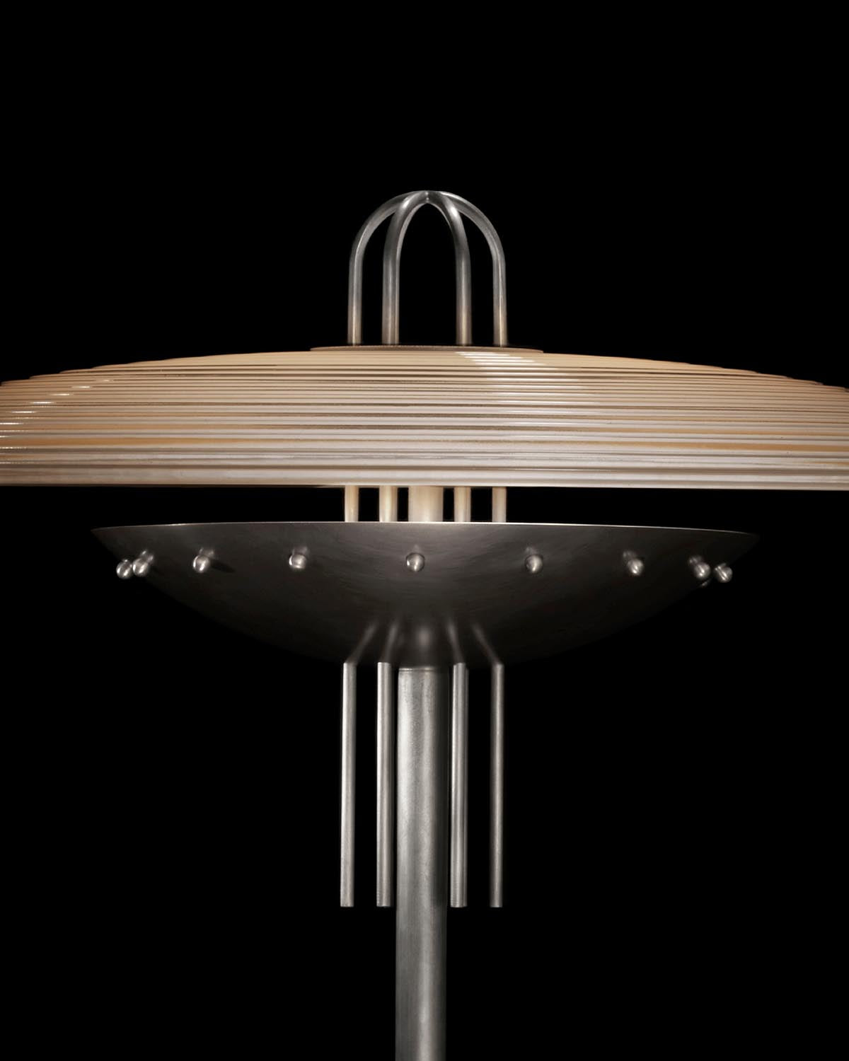 Close-up of SIGNAL Y table lamp with layered wooden shade and matte metal dome with rivet details on black background