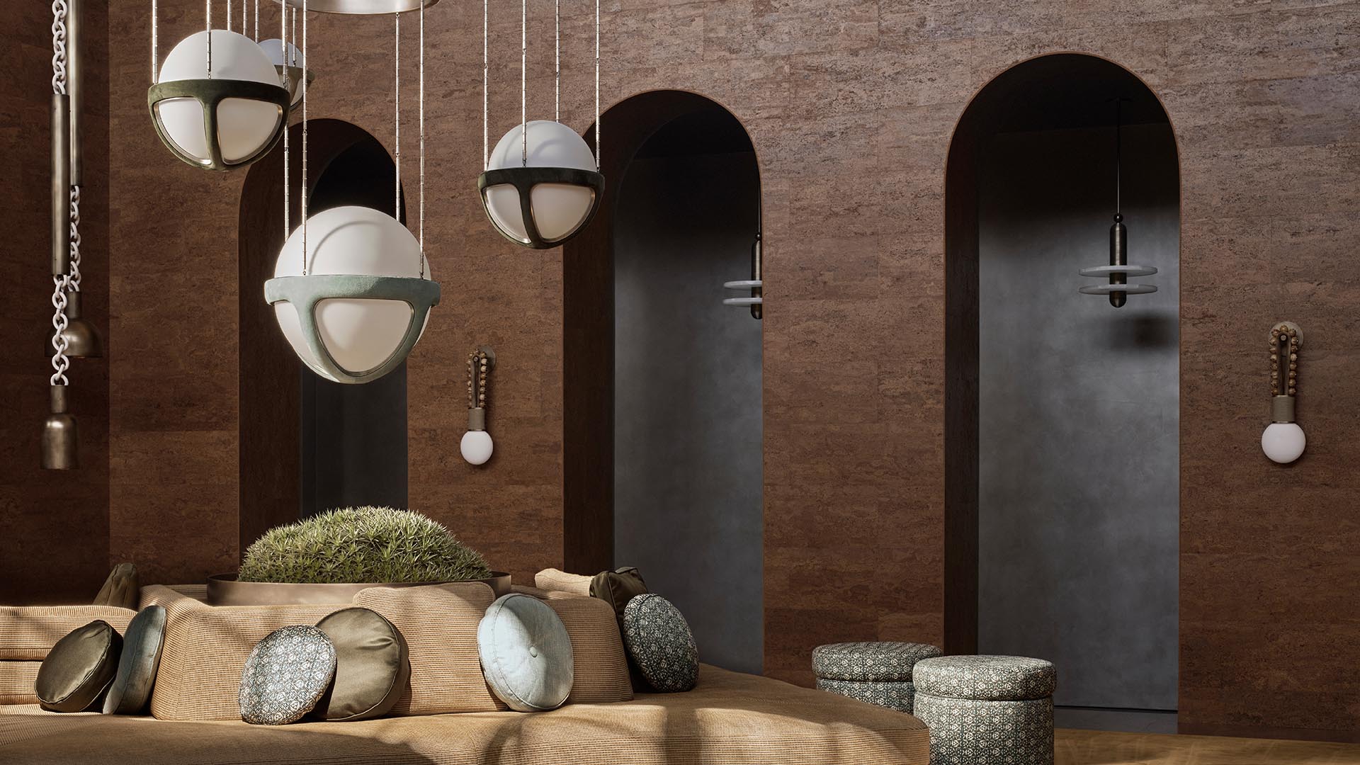 Interior with curved textured brown walls, three arched doorways, round pendant lights, and circular cushioned seating with pillows.